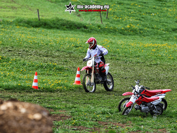 Beginner motorcycle course: a rider steers his motorcycle between the cones on the meadow