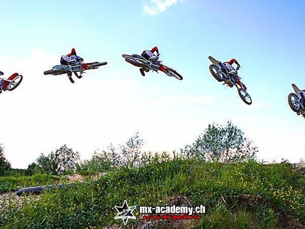 BMX and motocross: sequence shot showing a rider several times in the air over a green hill