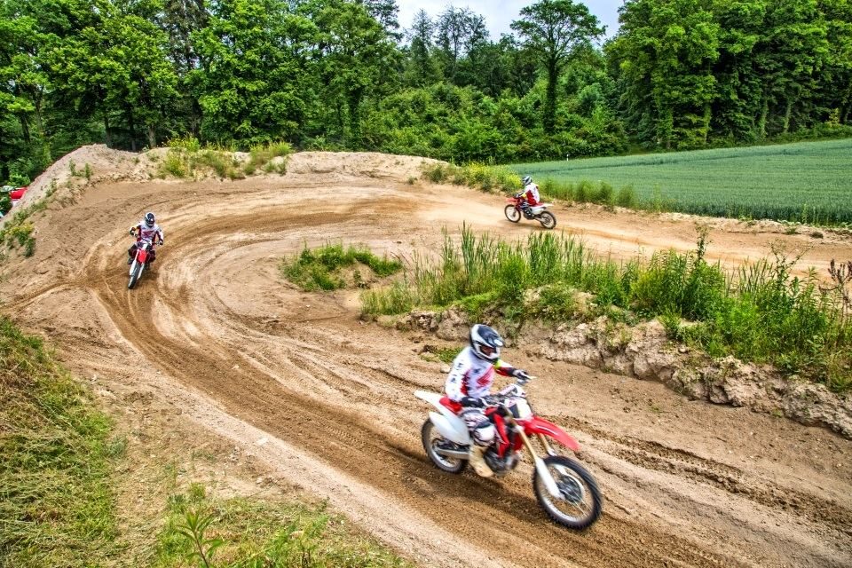 Directions to the track: twisty motocross track with several riders out riding on it