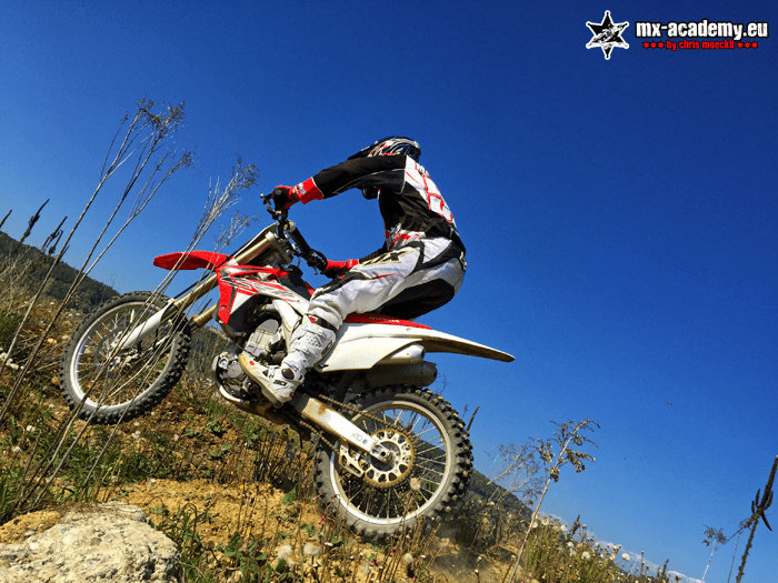 Enduro club for advanced riders: an enduro rider masters a steep climb on a hillside