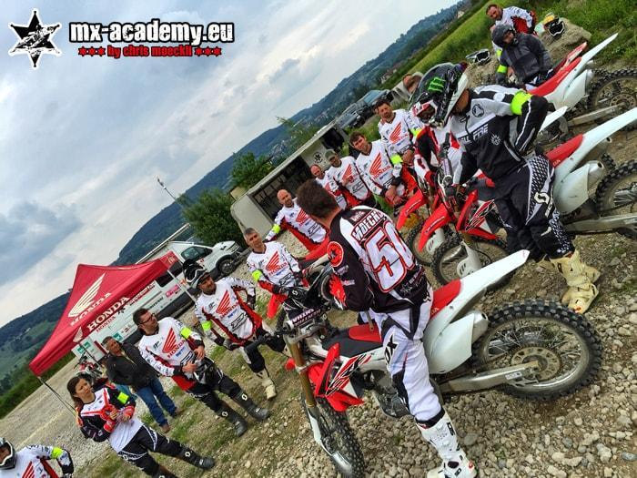 Enduro training with theory: a group of enduro riders in full gear at the briefing with the coach