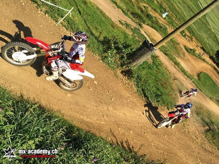 Freeride on a slope: motocross rider out on a steep, green, overgrown embankment