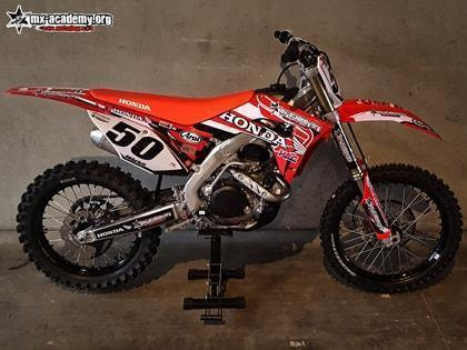 Honda motocross in the shop: a red Honda CRF with race number 50 on display