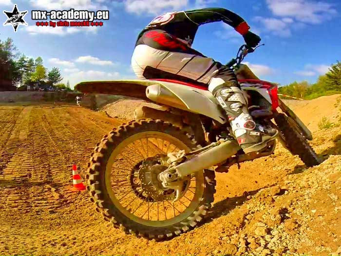 Lean angle training up close: rider and motorcycle leaned over in the middle of a corner