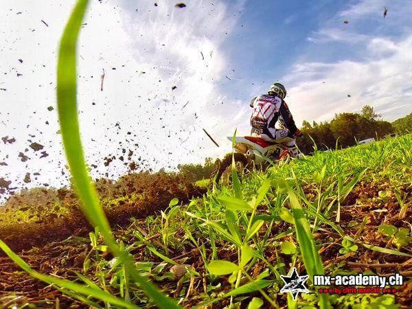 Motocross photos taken from the grass: rider with race number 50, dirt flying