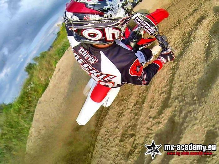 Motocross team training: close-up of a rider in mid-jump over the track