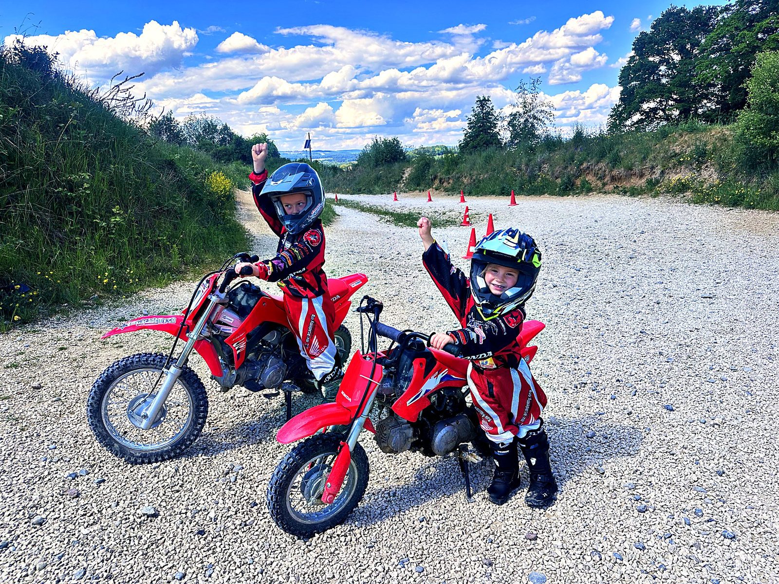 Motocross training for kids: children on Honda kids' motorbikes at the start, one raising an arm