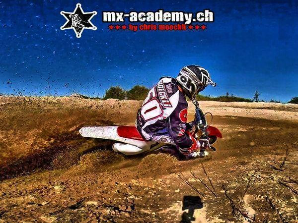Motorbike off-road: rider with number 50 leans deep into the corner, his rear wheel throwing up dirt