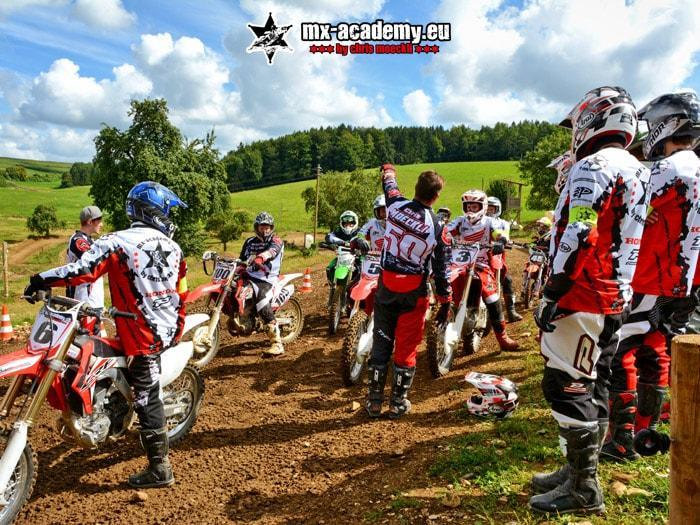 Motorcycle safety training in a group: several riders together with their coach at the facility