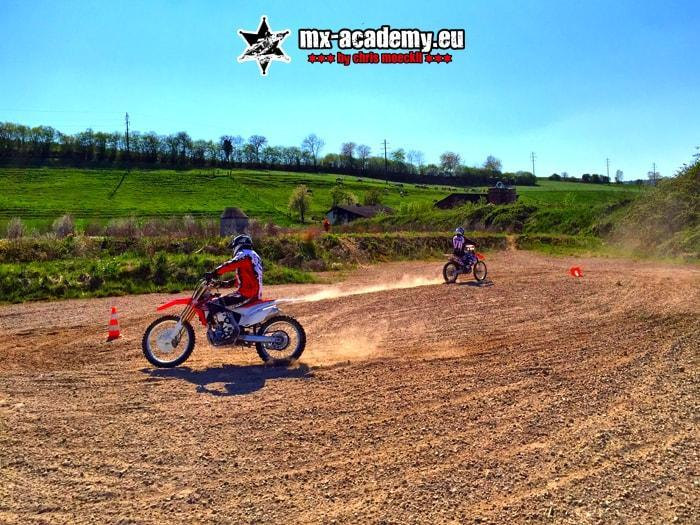 Motorcycle safety training on the practice area: a rider steers his motorcycle past the cones