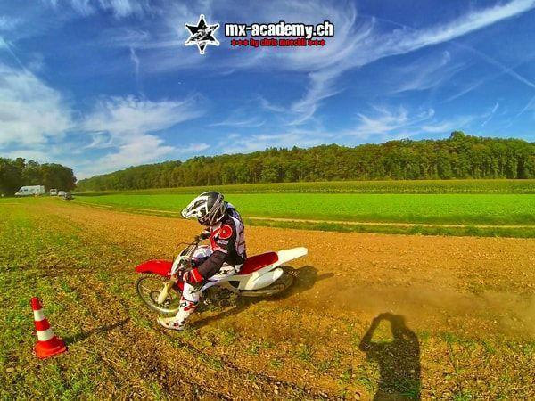 MX photos: cornering close to the cone, a shadow falls into the picture in the foreground