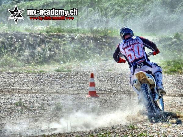 MX photos: race number 50 in the gravel corner next to a cone, with dust rising