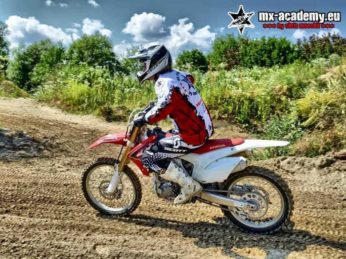 Supermoto riding technique off-road: a rider out on the off-road track between the trees