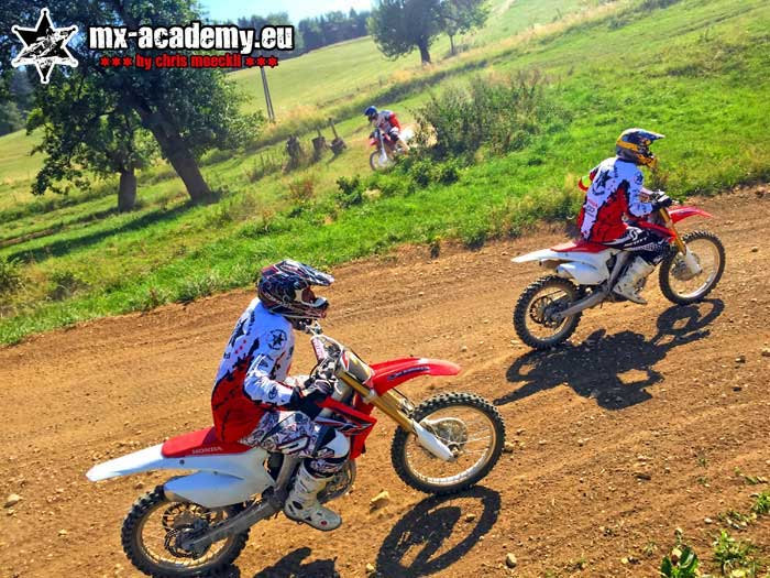 Team building events with motocross: two riders take a corner together on the track