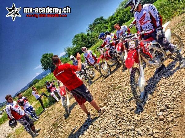 Try motorsport: a coach in red shows a group of riders by their Honda bikes the next exercise